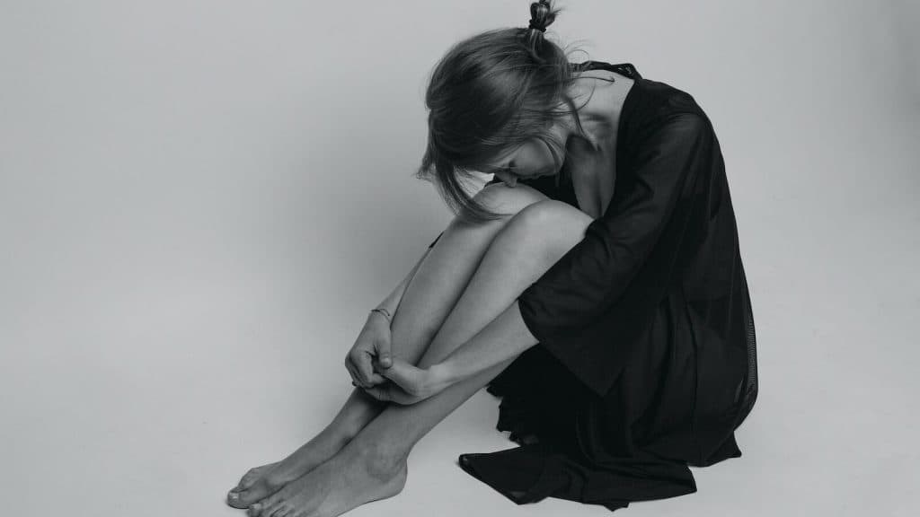 woman in black dress sitting on floor