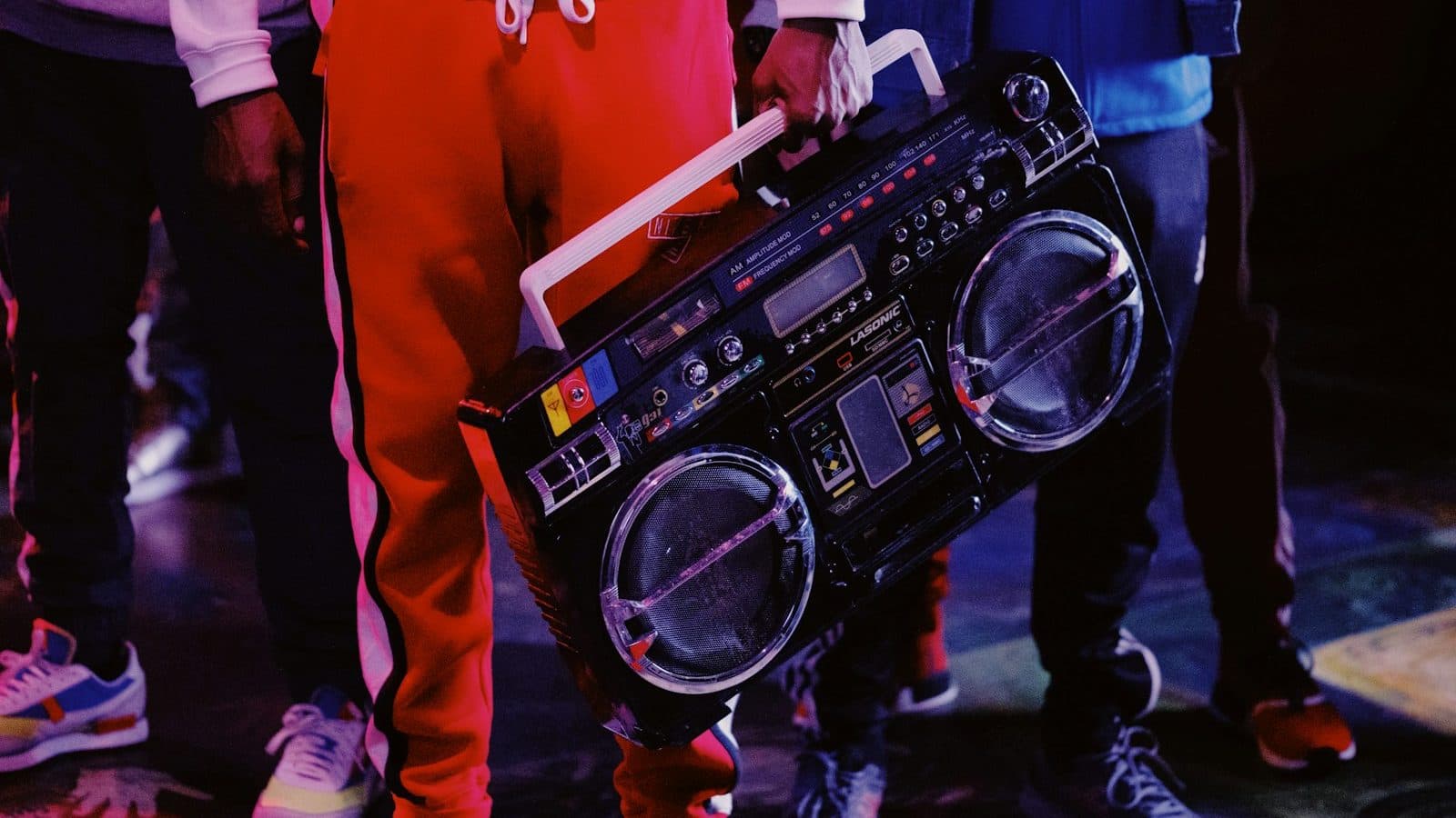 man in red jacket holding black dj controller