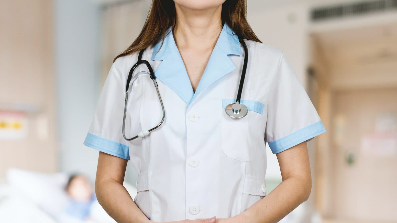 woman in white button up shirt and blue stethoscope